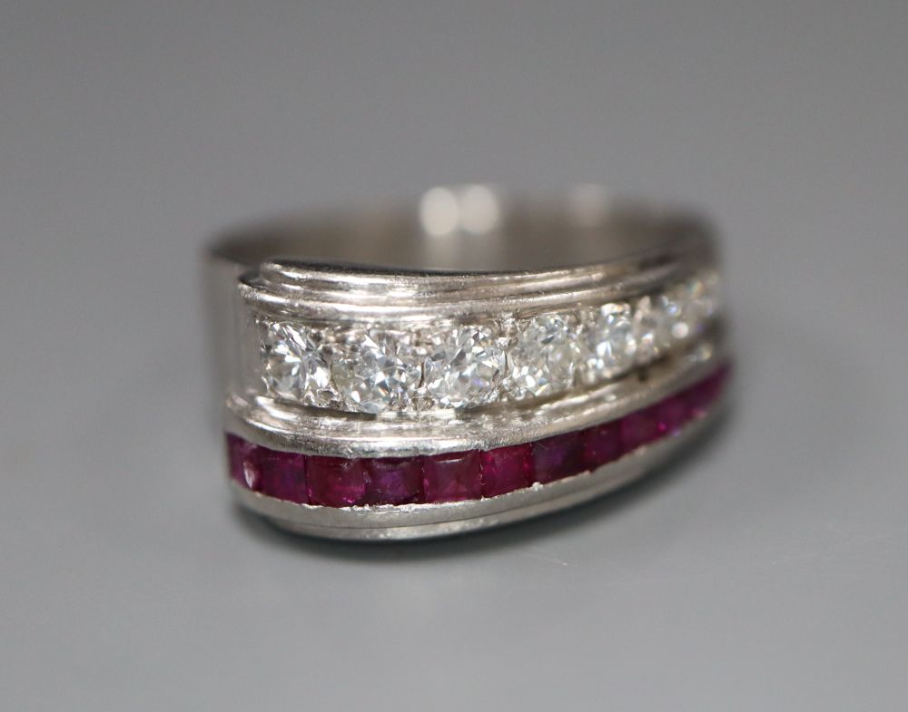 A stylish white metal (stamped Plat), graduated ruby and diamond set twin row dress ring, size O, gross 7.2 grams.